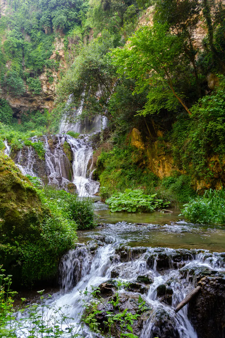 Best day trips from Rome in Tivoli with cascading waterfalls surrounded by rich greenery