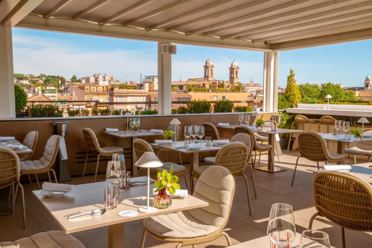 Best rooftop bars in Rome at Acquaroof Terrazza Molinari with an outdoor dining area overlooking Romeâs rooftops