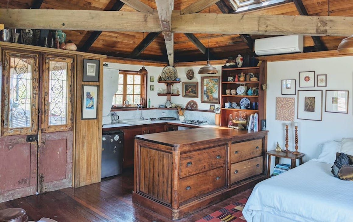 A rustic style farm house with wooden benches and cupboards at one of the best romantic getaways in Victoria.