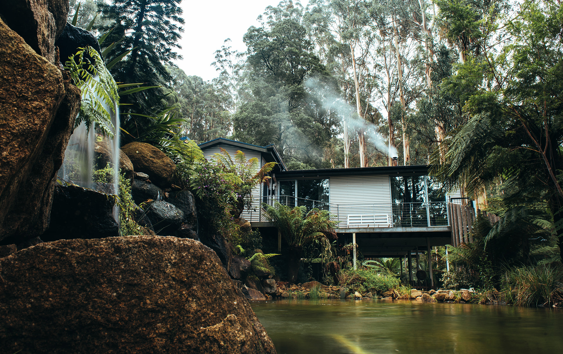 A house with a billabong and waterfall one of the best airbnbs in Victoria.