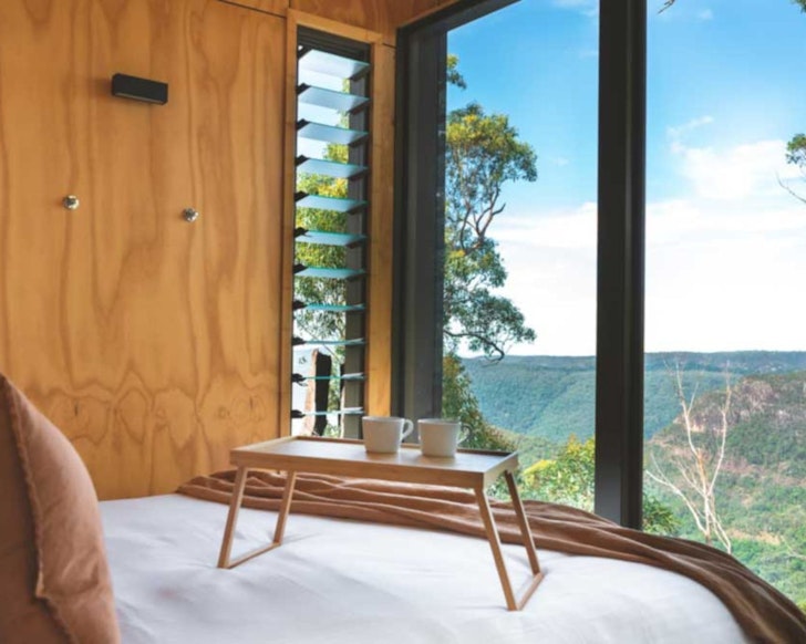 A bed with a view at Binna Burra Lodge one of the best Gold Coast romantic getaways