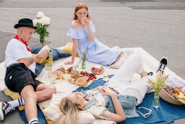 A group of people enjoying a rooftop picnic.