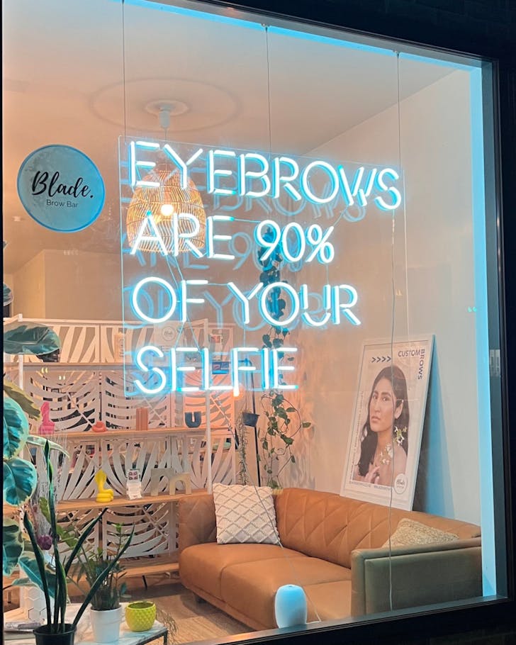 Looking through the front window into Blade Brow Bar. 