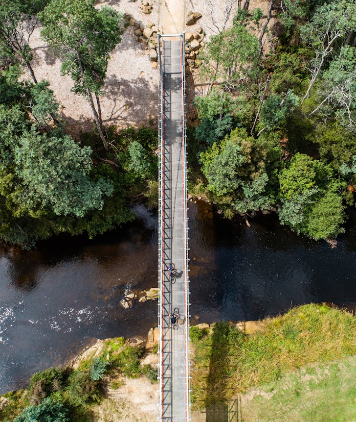An aerial view of a suspension bridge at Blue Derby.