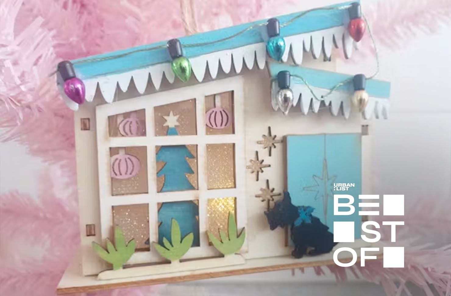 A cute Christmas decoration made from a blue-roofed vintage house. 