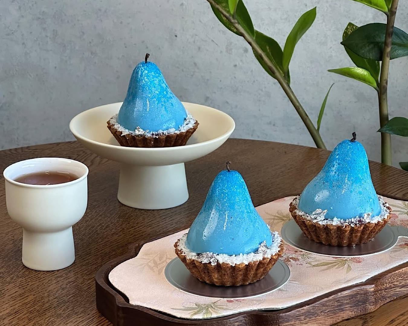 Bright blue-coloured pear tarts. 