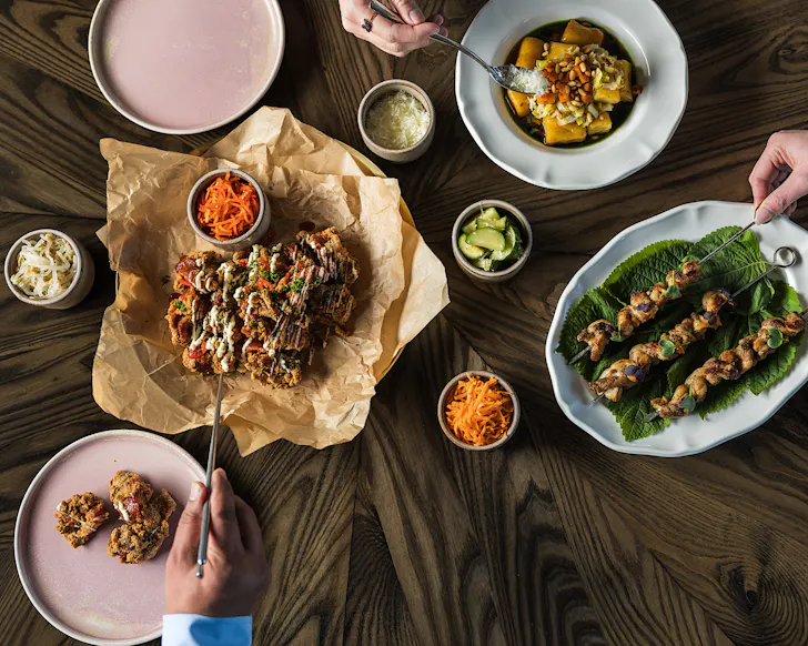 Hungry punters get stuck into a table laden with contemporary Korean dishes at Boda.