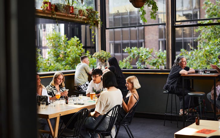 A group of people on a rooftop at one of the best CBD bars in Melbourne.