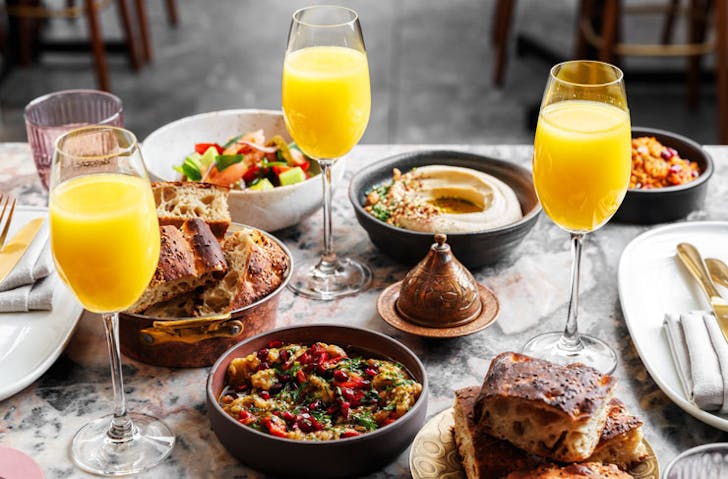 A spread of meze and mimosas at Sydney rooftop restaurant, Babylon. 