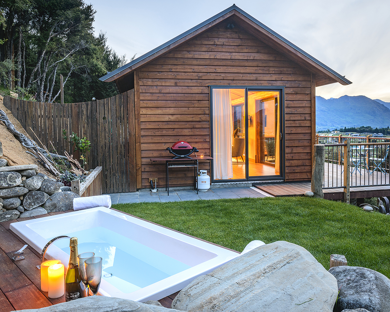 Boutique mountain hideaway shows a bath on the lawn.