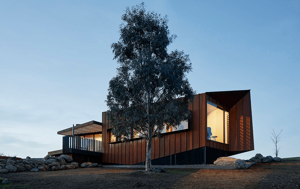 A large rustic design home perched on a hill. 
