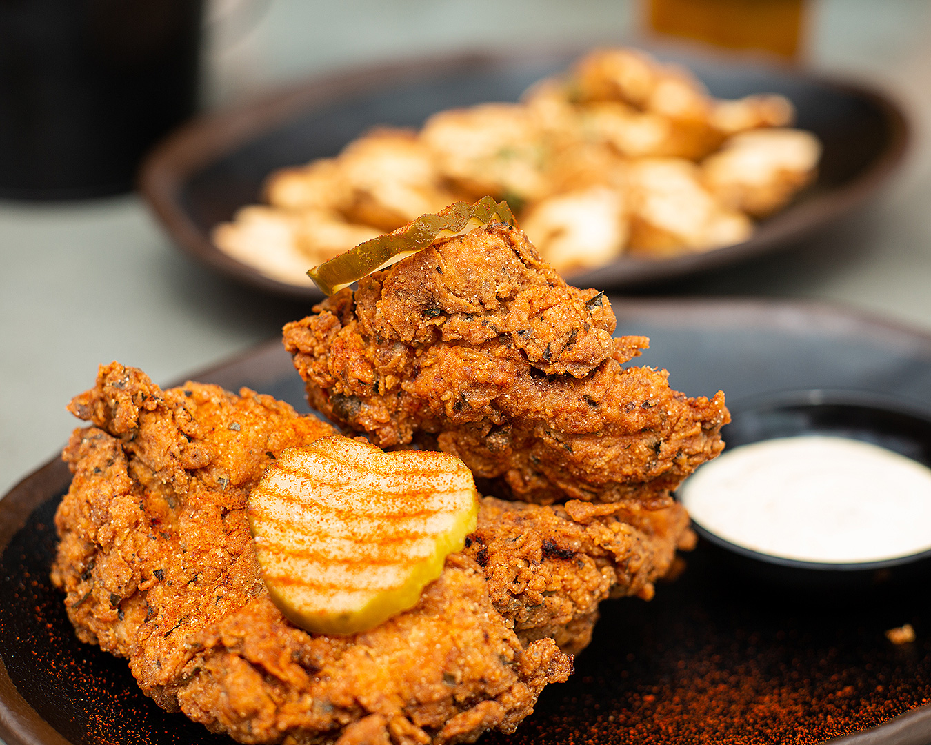 Crunchy, juicy fried chicken topped with pickles from Brew'd Hawt, one of the best spots for fried chicken in auckland.
