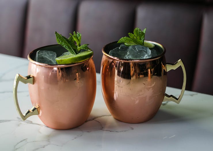 two cocktails in copper mugs