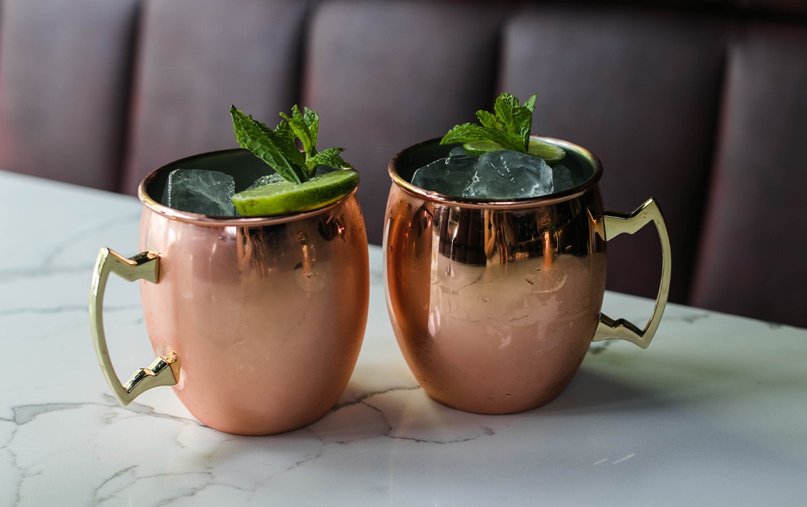 two cocktails in copper mugs