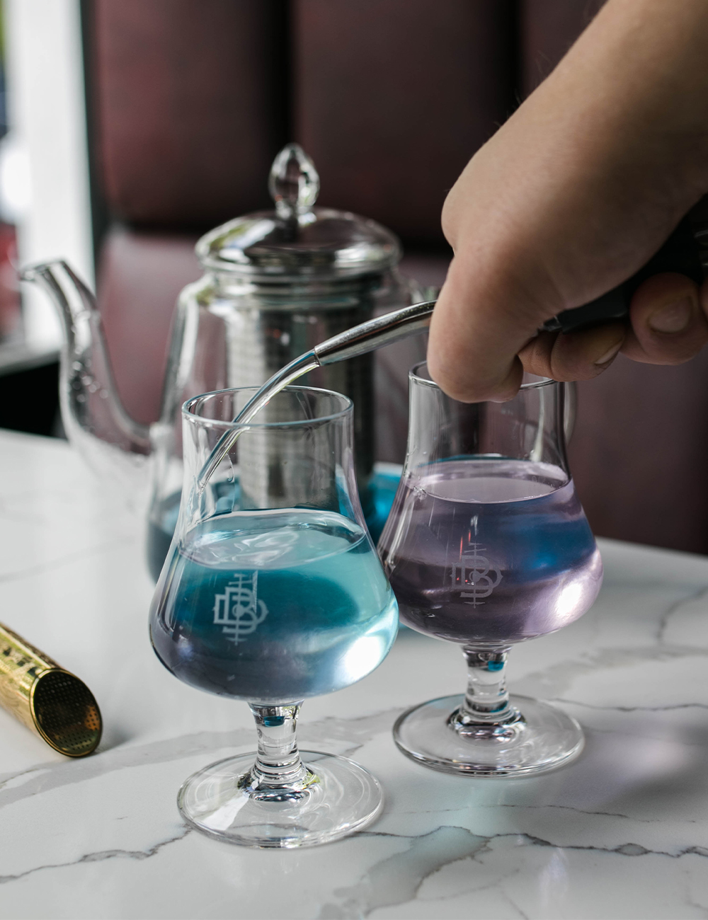 Colour changing gin cocktail being poured