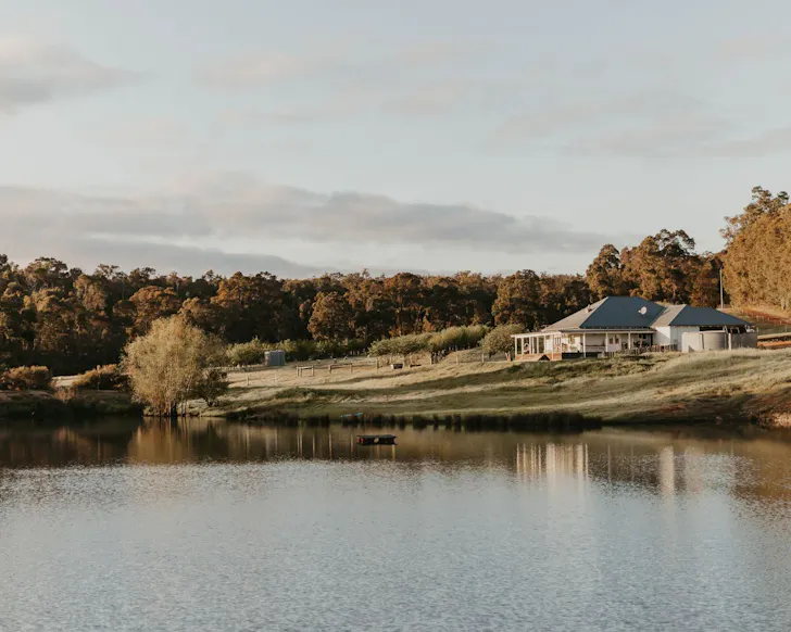 A view of Brookhampton Road Farm across the dam, best WA Airbnbs