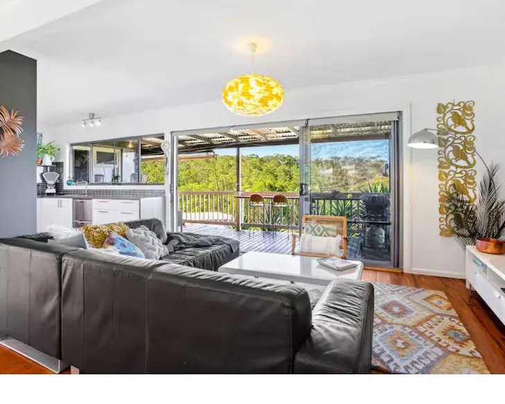The living space and balcony with views at Buena Vista 62 Airbnb one of the best accommodation options near Narooma NSW