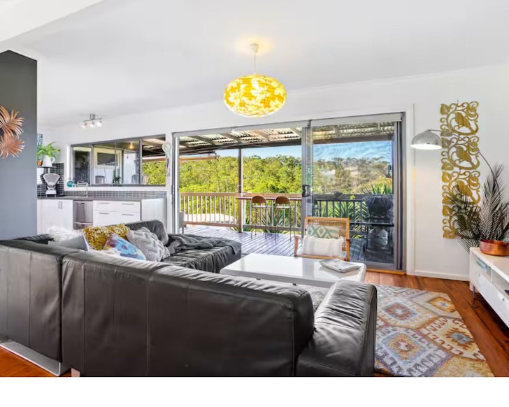 The living space and balcony with views at Buena Vista 62 Airbnb one of the best accommodation options near Narooma NSW