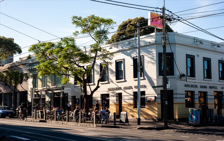 A corner pub with blue skies behind it. 