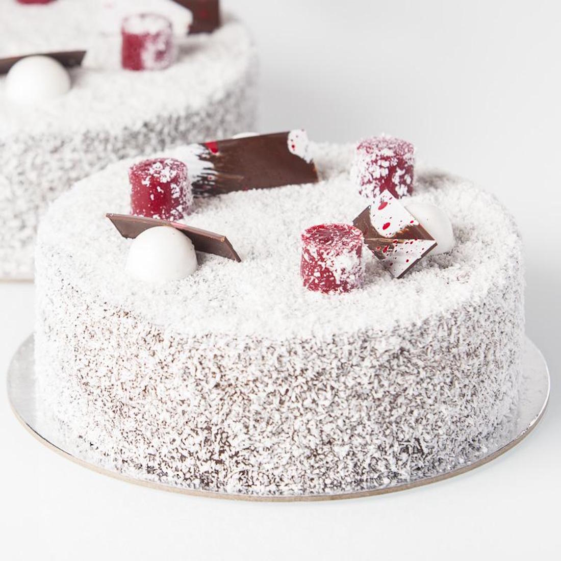 A lamington cake sits atop silver foil.