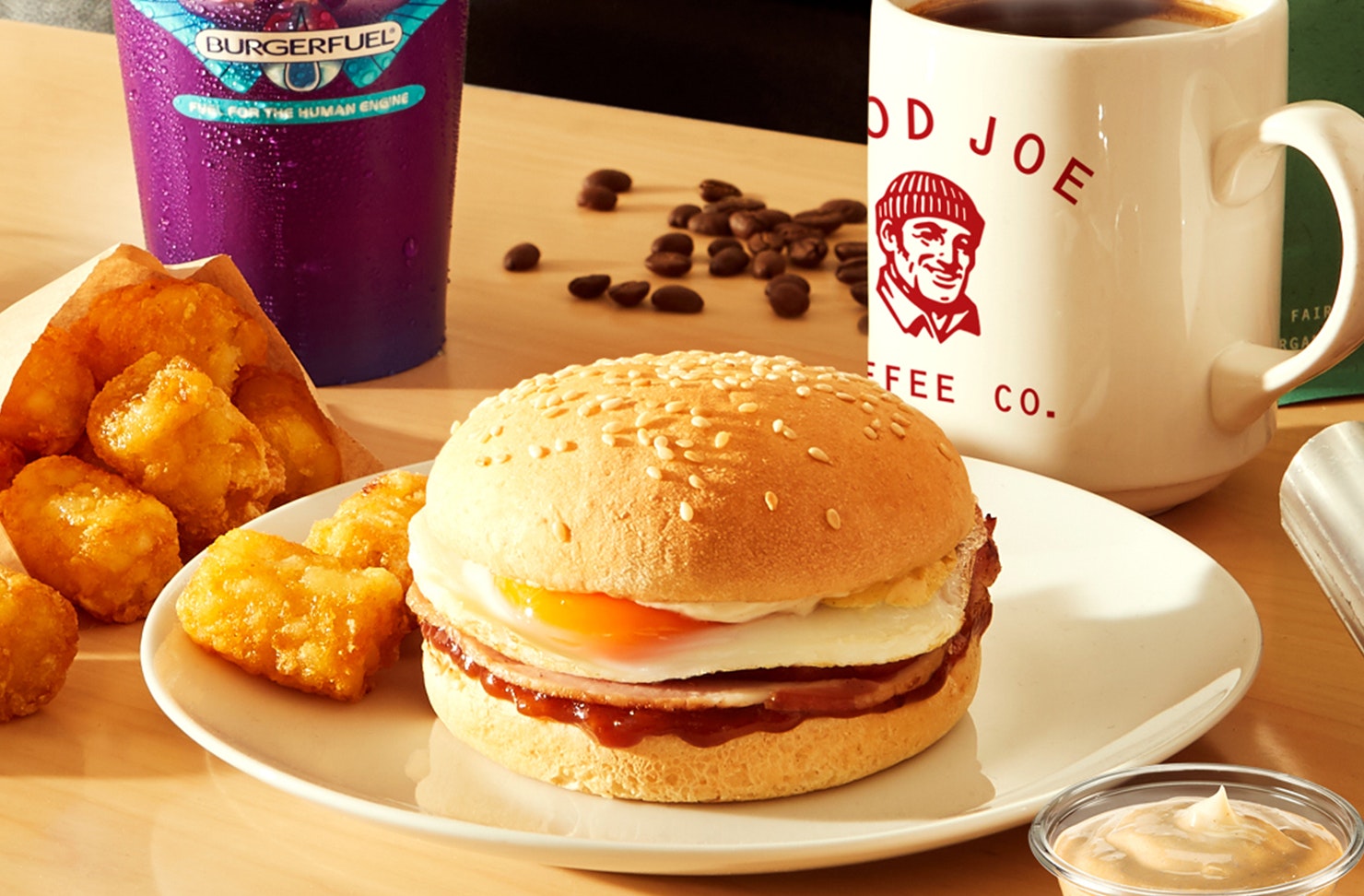 A DEGGolition Derby Burger surrounded by Smash Browns and a mug of Good Joe coffee.