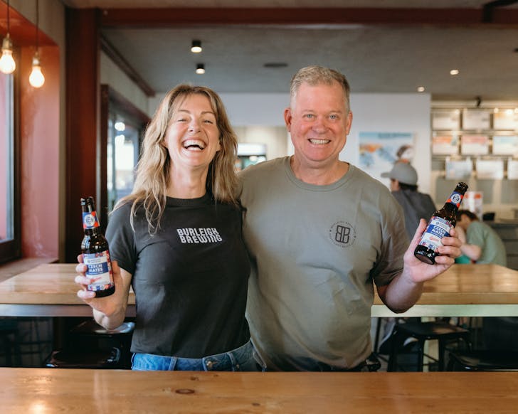 Male and female at Burleigh Brewing Company holding up a beer each called Czech Mate