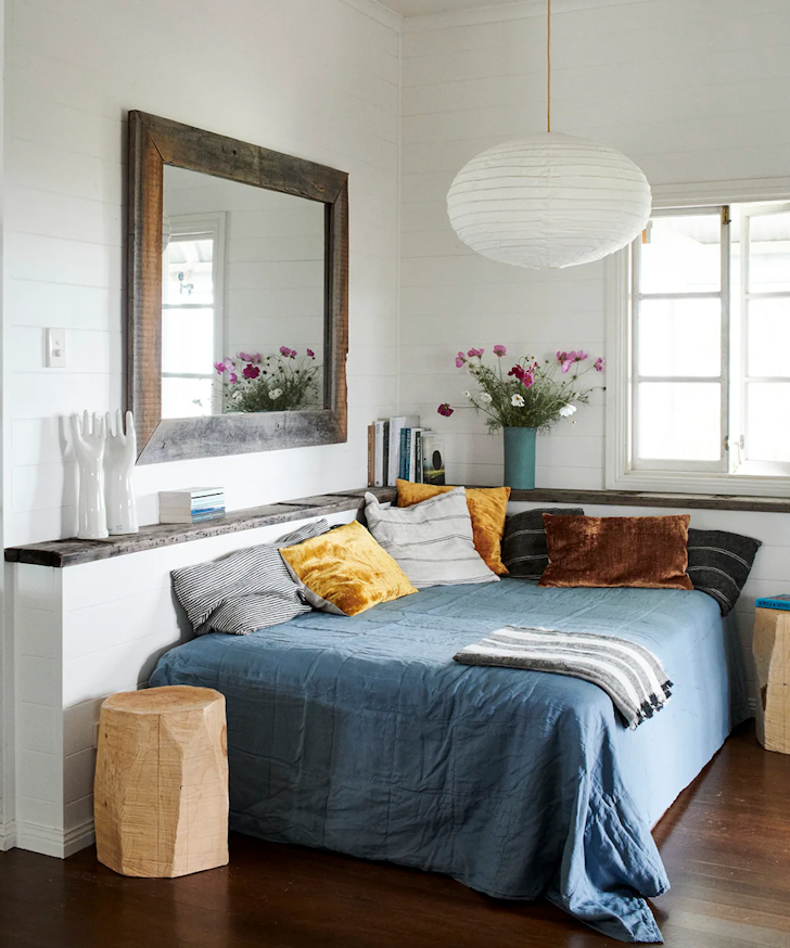 A cosy day bed with a blue cover at Byron View Farm one of the best Byron Bay Airbnbs