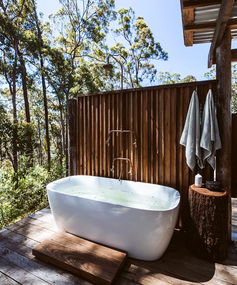 an outdoor bath surrounded by bushland