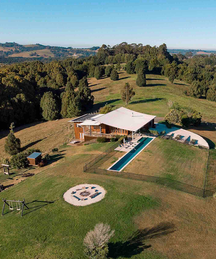 An aerial view of the building and pool at Temple Farm House one of the best Byron Bay Airbnbs