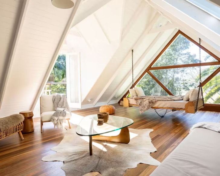 The living space with triangle window at Byron Hinterland Escape one of the best kid-friendly Airbnbs in Australia