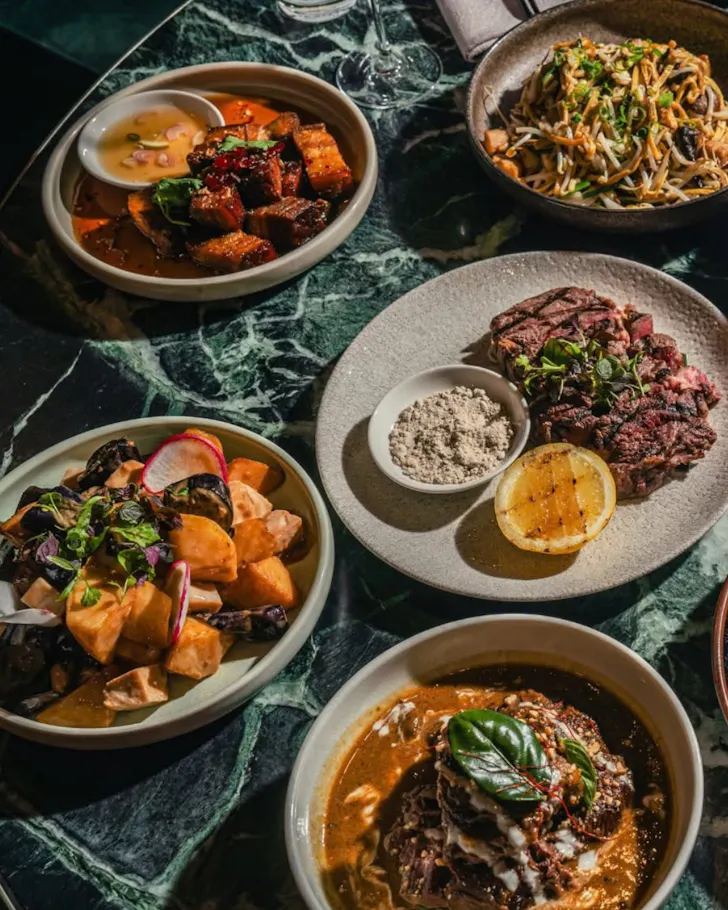 A bright table full of Asian food at CHU Restaurant by China Doll.