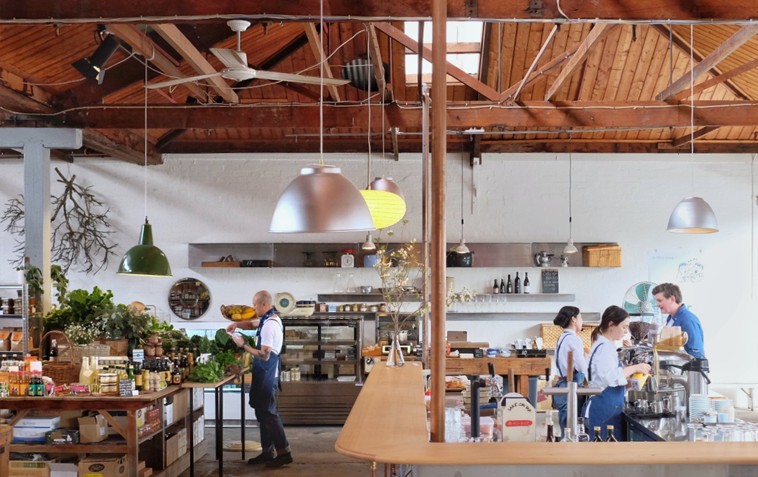 A large cafe space inside a warehouse. 