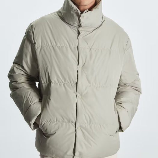 A light grey jacket, one of the best men's puffer jackets. 
