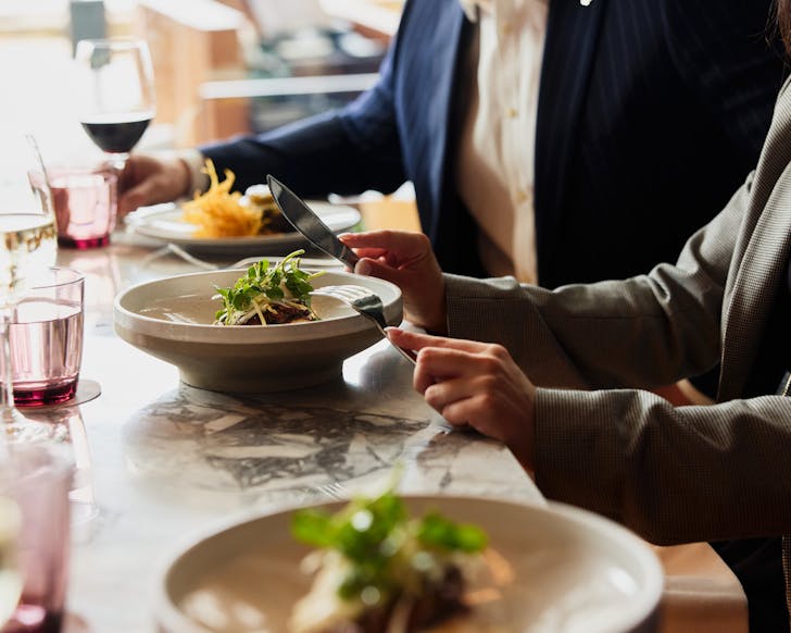 Hands holding a knife and fork