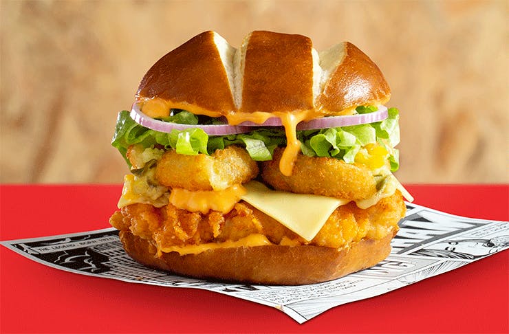 The new Chicken Treat Tempta Boom burger featuring a pretzel bun, lettuce, spicy chicken and cheese.