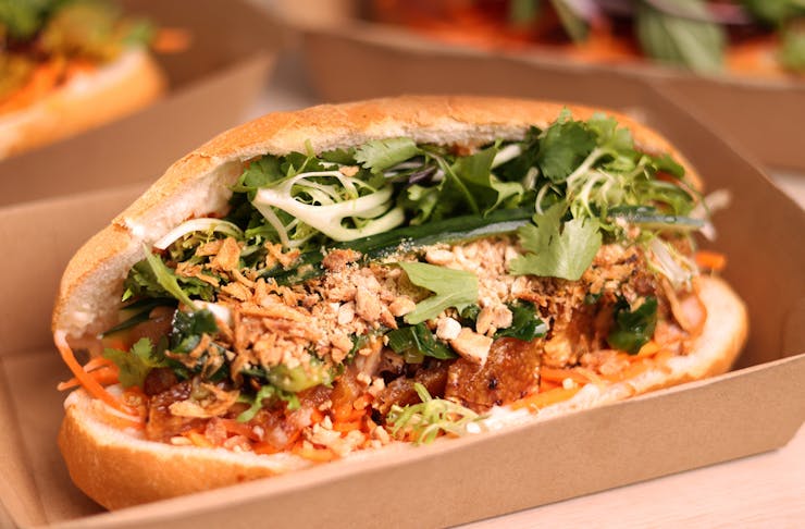 A banh mi with shallots on top. 