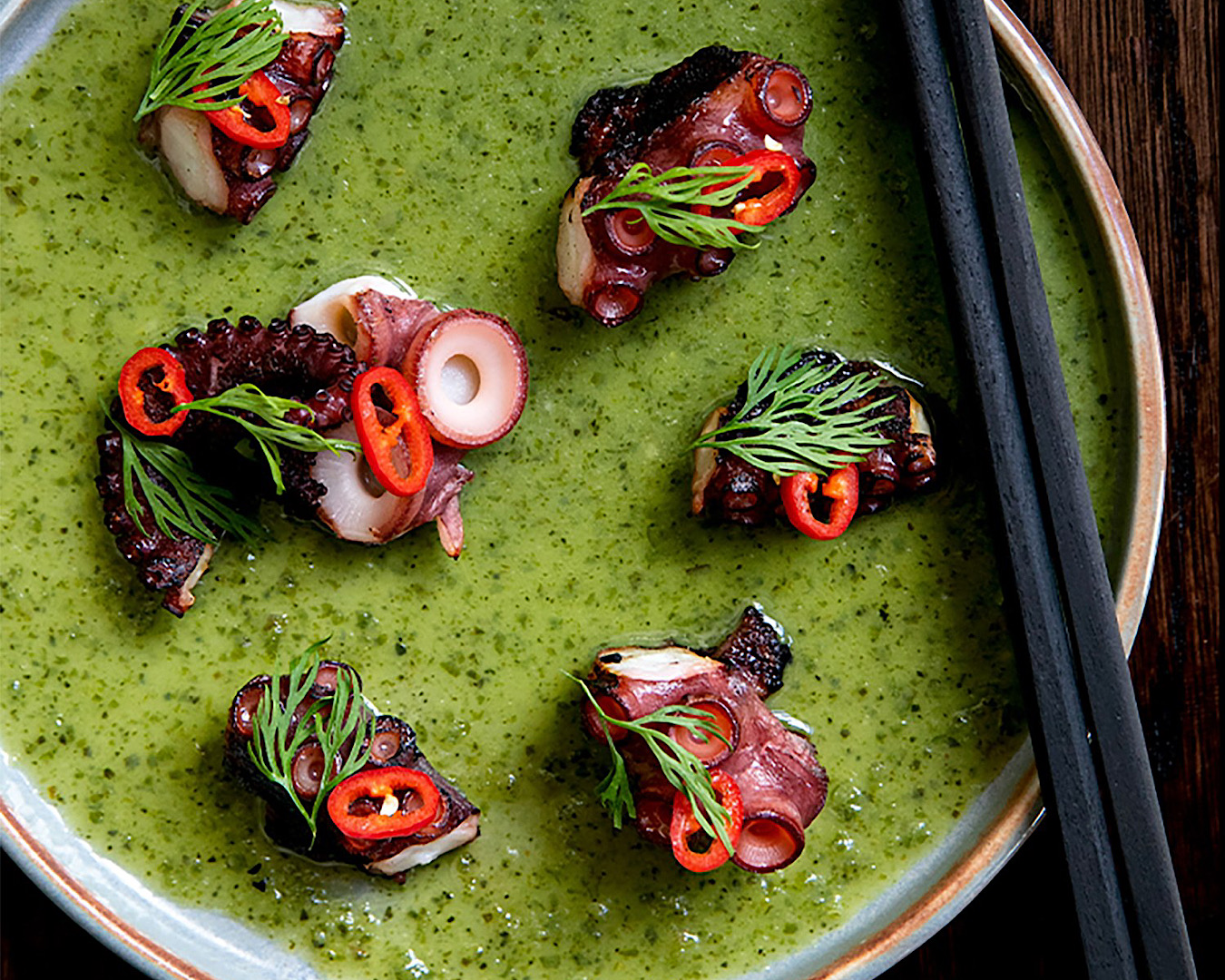 Octopus bites in a vibrant green sauce from Cafe Hanoi, one of the best places to eat in Auckland this summer. 