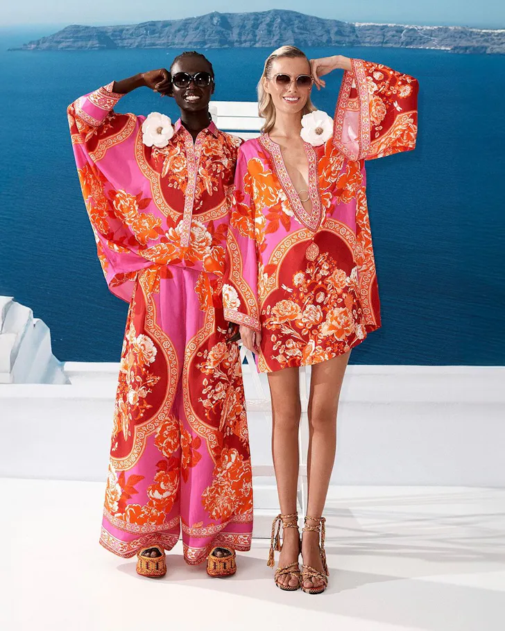 Two models wear vibrant pink outfits by Camilla one of the best Australian fashion labels
