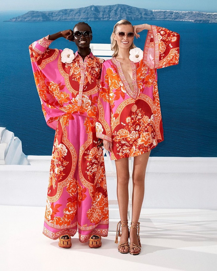 Two models wear vibrant pink outfits by Camilla one of the best Australian fashion labels