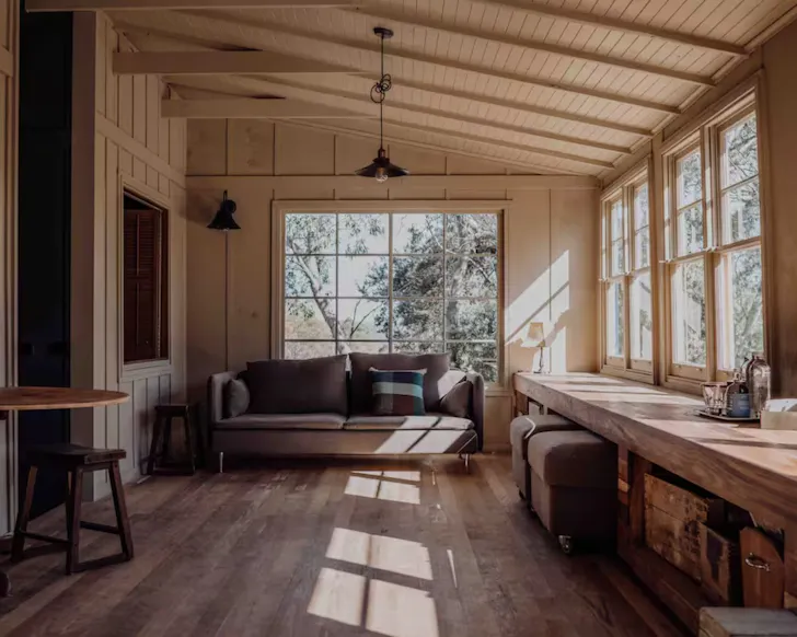 The rustic living space at Camp Nowhere one of the best lake houses and tiny homes in Tasmania
