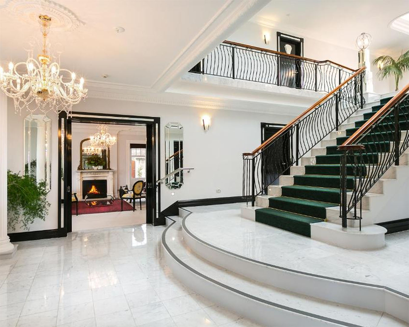 An incredible white marble entrance hall complete with chandeliers and elegant touches at Camp Estate by Larnach Castle, one of the best accommodation in Dunedin.