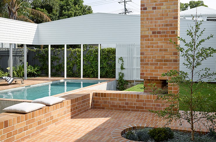 A shot of the brick courtyard and pool of the Cantala Avenue House.