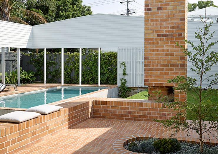 A shot of the brick courtyard and pool of the Cantala Avenue House.