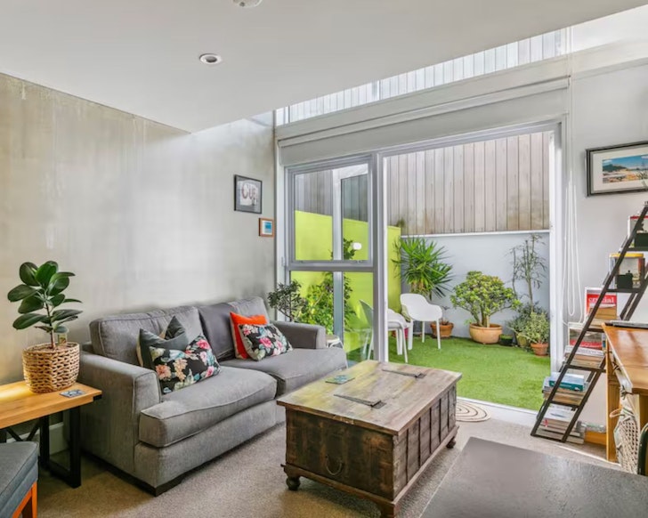 The living space looking out to the garden at Captivating Canvas one of the best Wellington Airbnbs