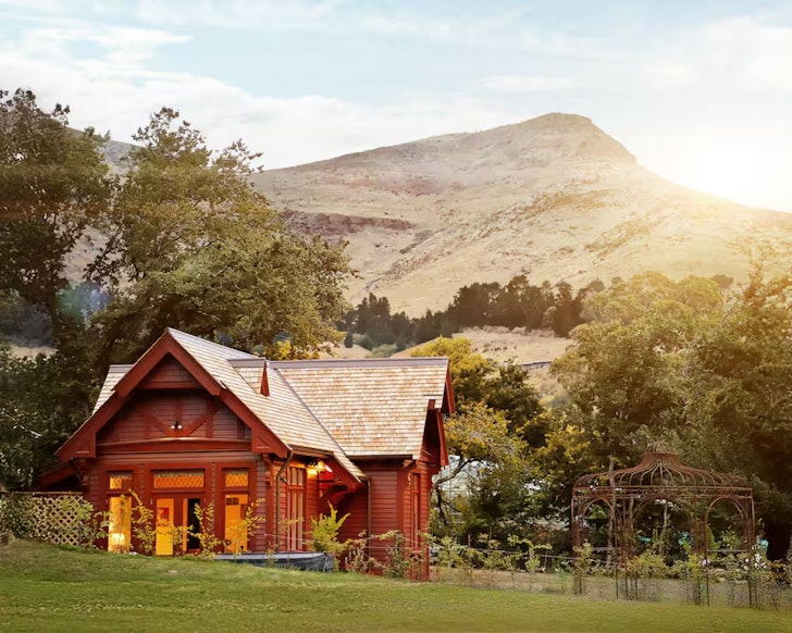 The exterior view of Casterton Cottage romantic stay surrounded by garden in Christchurch, New Zealand