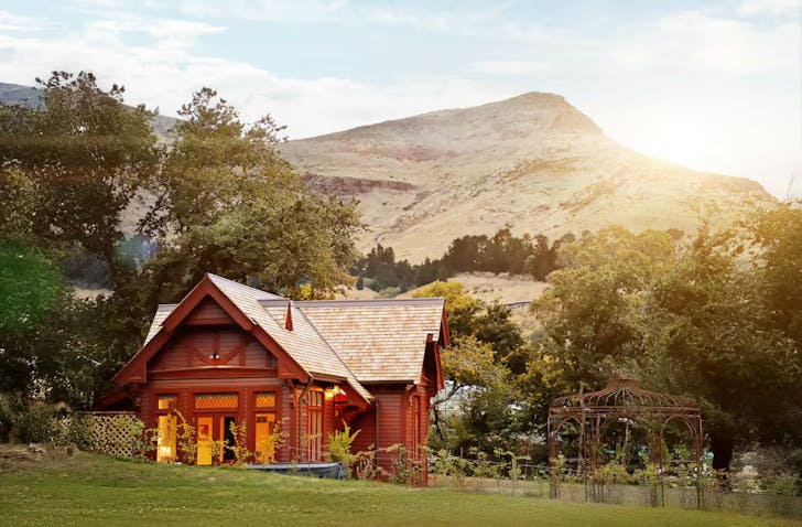 An exterior view of Casterton Cottage romantic Airbnb surrounded by garden in Christchurch, New Zealand