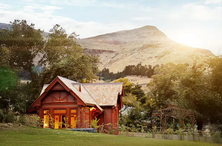 An exterior view of Casterton Cottage romantic Airbnb surrounded by garden in Christchurch, New Zealand