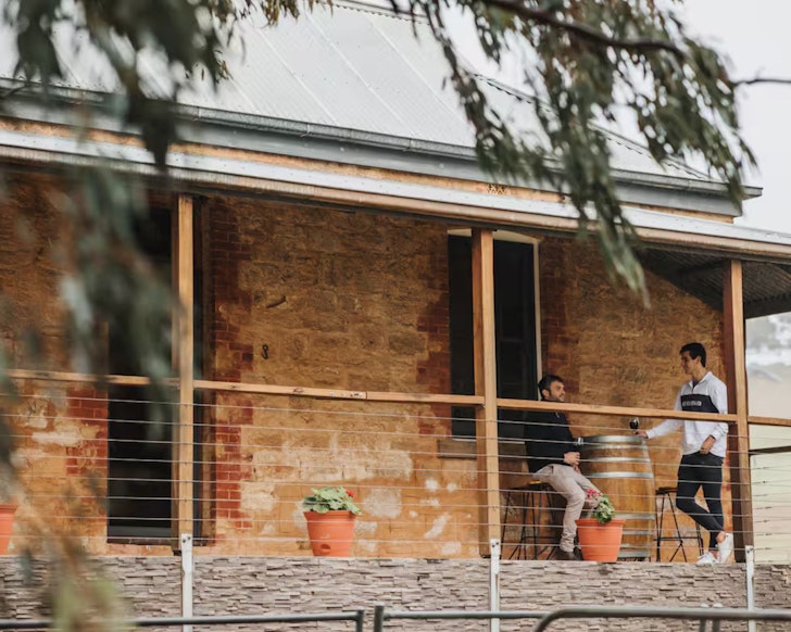 Two male guests enjoy the verandah at Cedar Cottage accommodation one of the best in Clare Valley