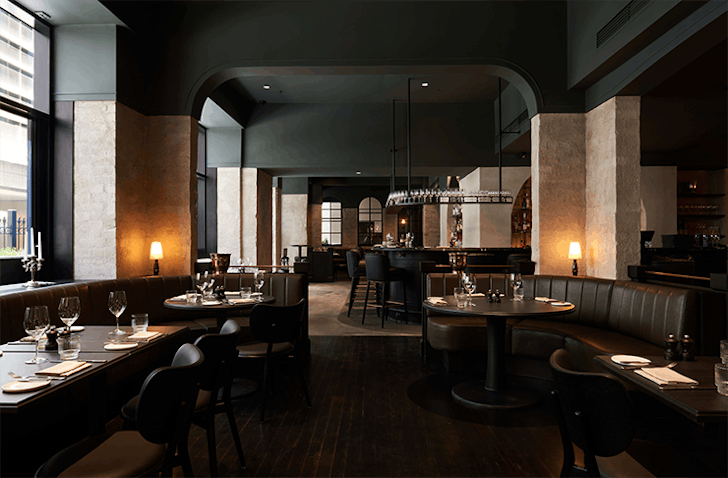 A sleek dimly lit diner with booth couches, a top private dining room in Melbourne. 