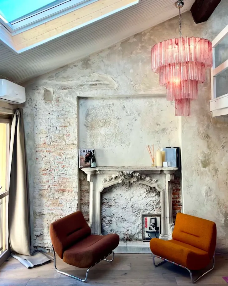 The pink chandelier at Charming Design Attic best Milan Airbnbs